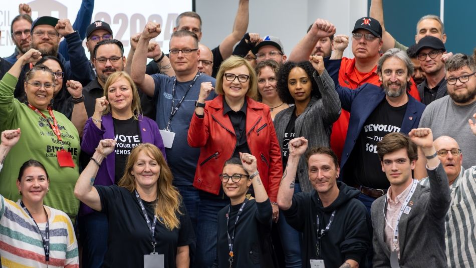 A large group, fists raised.