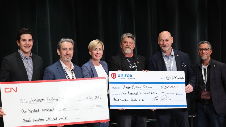 Group photo holding cheque