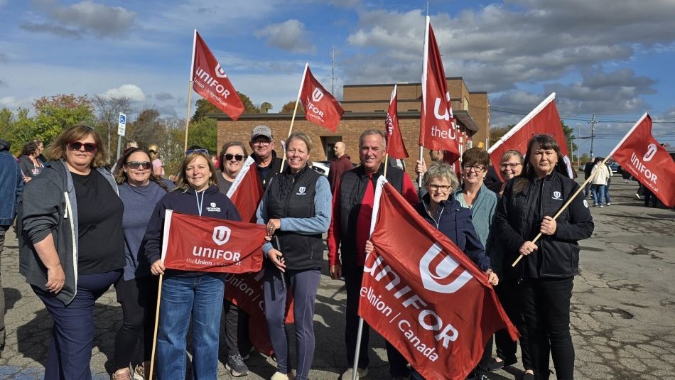 Unifor Atlantic Regional Director Jennifer Murray stands with a group of Unifor members holding flags at a rally to support long-term care workers in Nova Scotia.