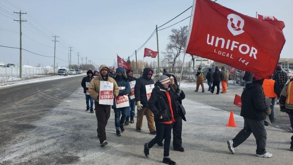 a group of people walking on a road with signs