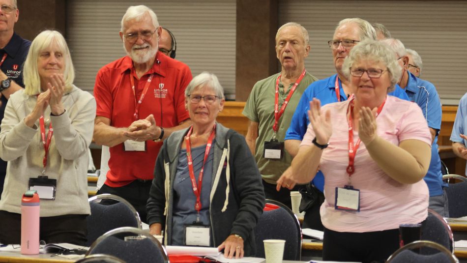 five people standing clapping