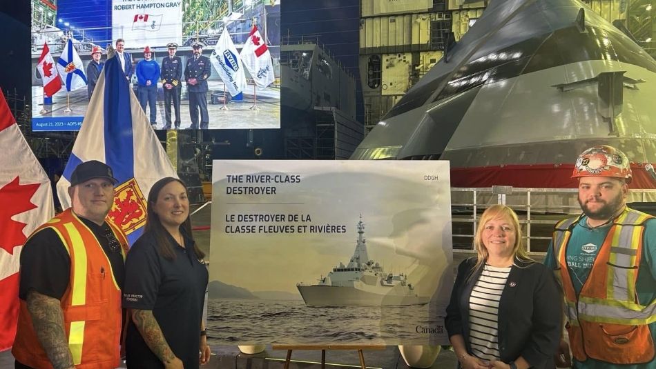 Atlantic Regional Director Jennifer Murray stands with MWF Local 1 members in the Halifax Shipyard
