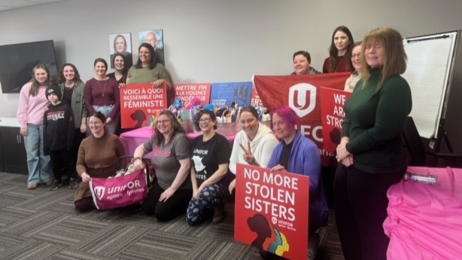 A dozen Unifor sisters posing for a group photo.