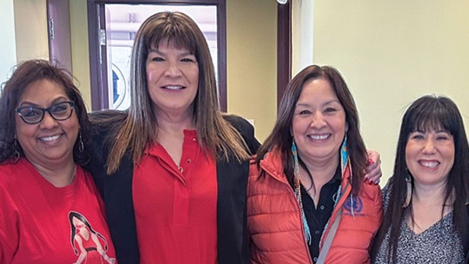 Four women smiling 