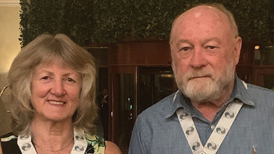 a man and a women wearing an award around their necks