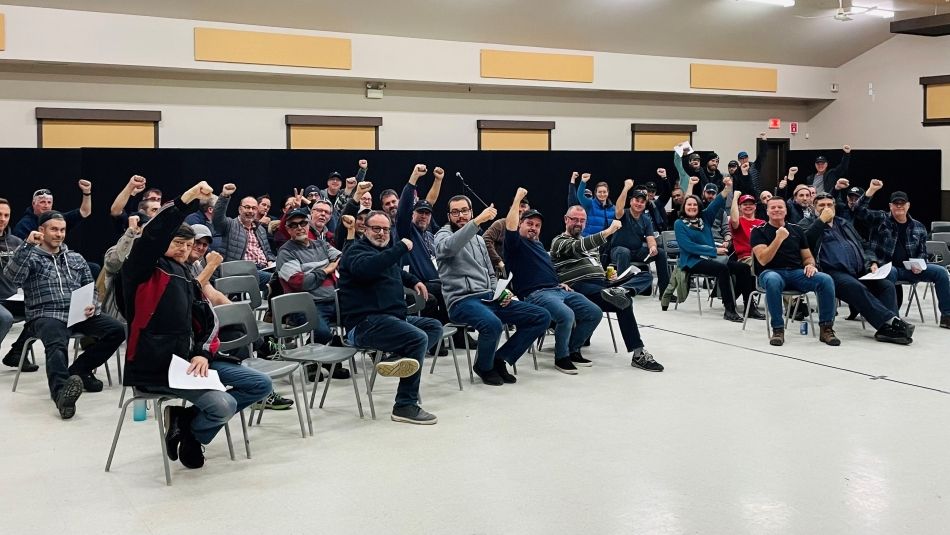 St. Lawrence Seaway ratification vote A large group of people sit in a room with fists raised as a show of strength