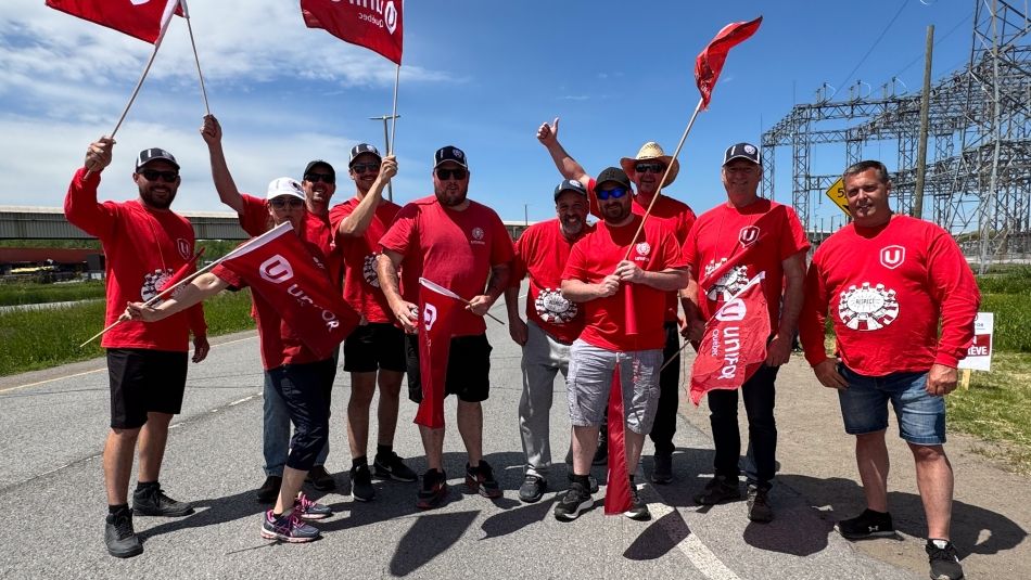 Small group shot of strikers in the street with flags