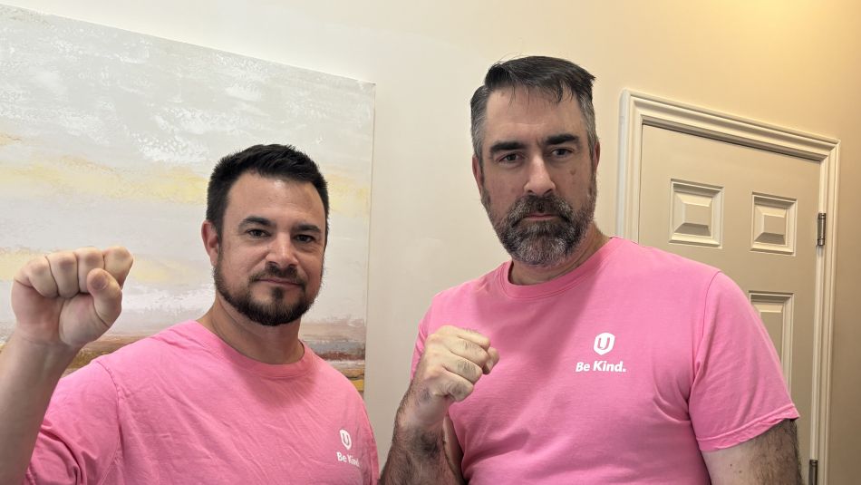 Two men in pink shirts
