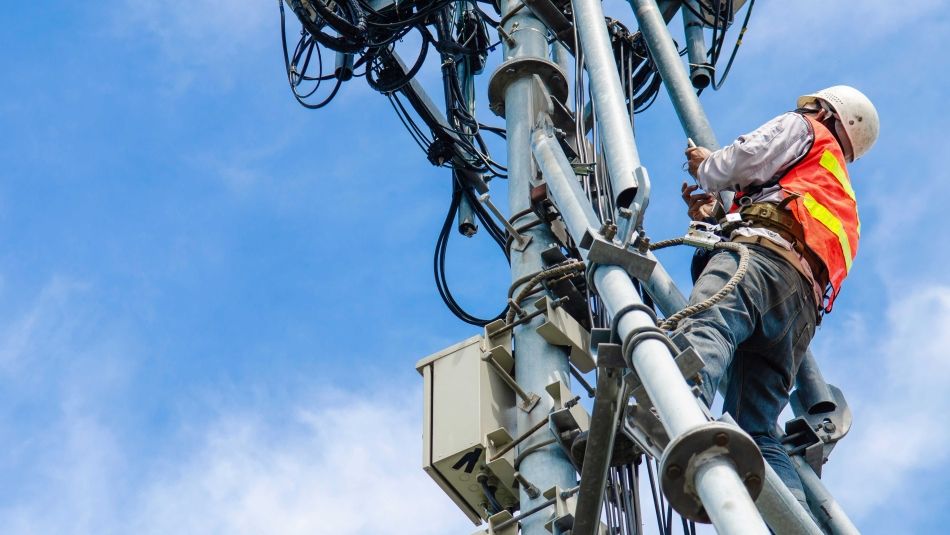 Telecommunications worker checks lines.