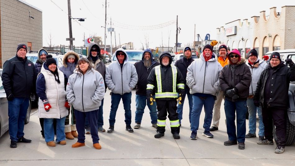 Titan Tool & Die picket line Windsor a goup stands outside in winter cloths