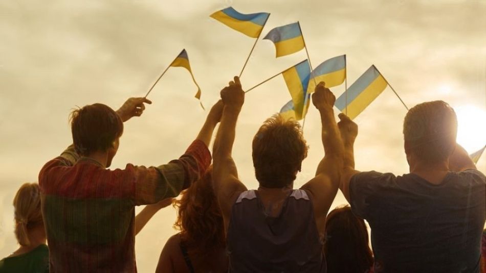 Ukrainians wave their country's flag.