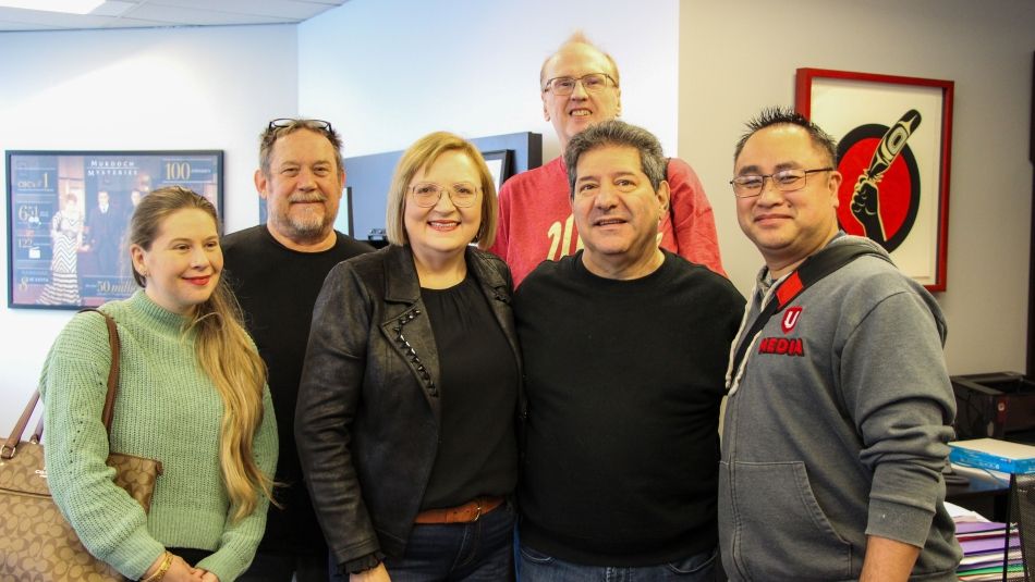 Six people standing smiling 