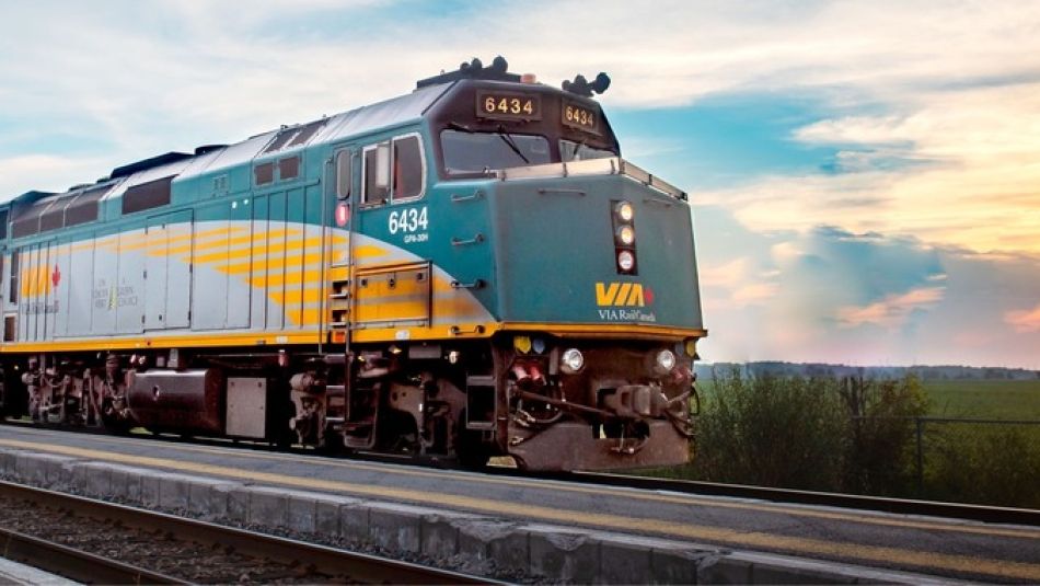 Via rail train approaching train station platform 