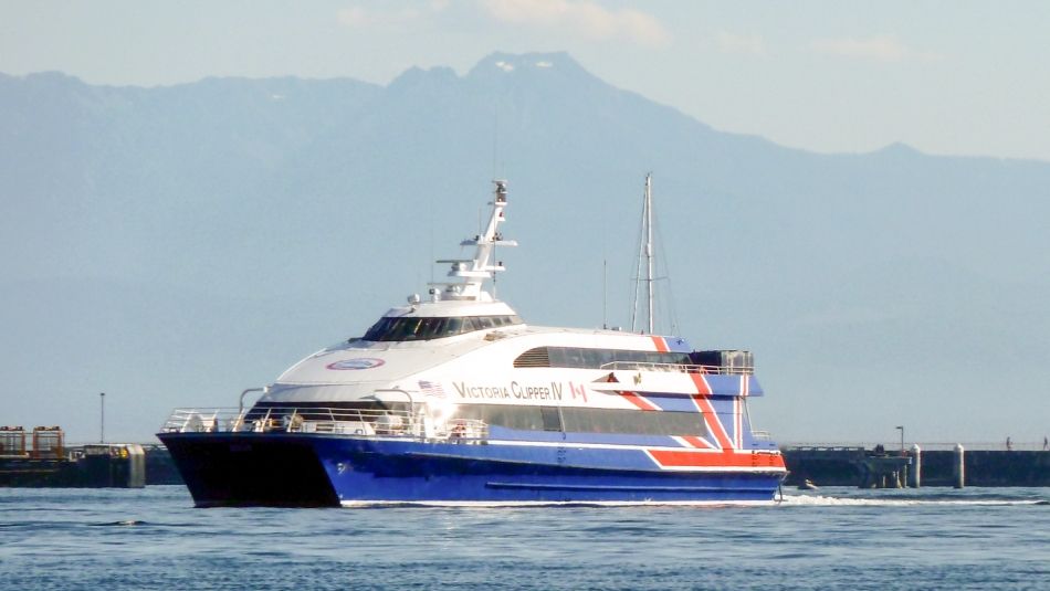 Ferry on the water with mountains in the background