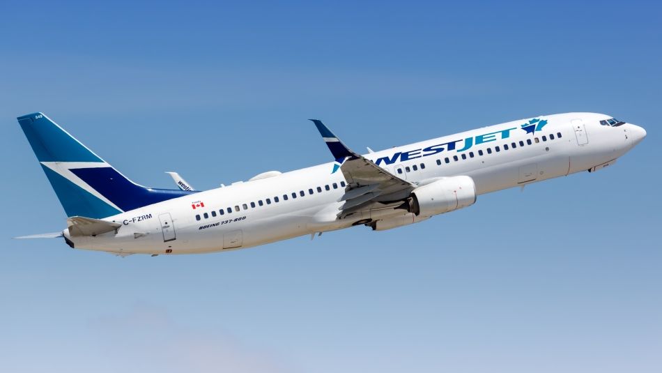 A WestJet plane ascending in the air.