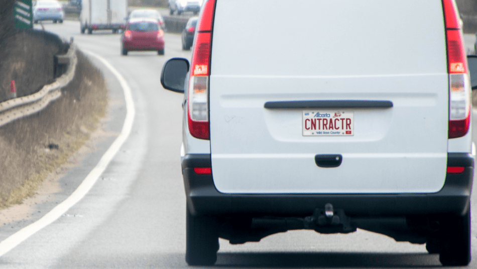 “Rear view of a white van with an Alberta license plate that reads ‘Contractor’”