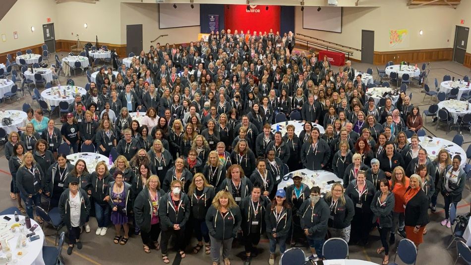 A large group of Unifor sisters photographed from a high angle at the Unifor Women's Conference in Port Elgin, Ontario
