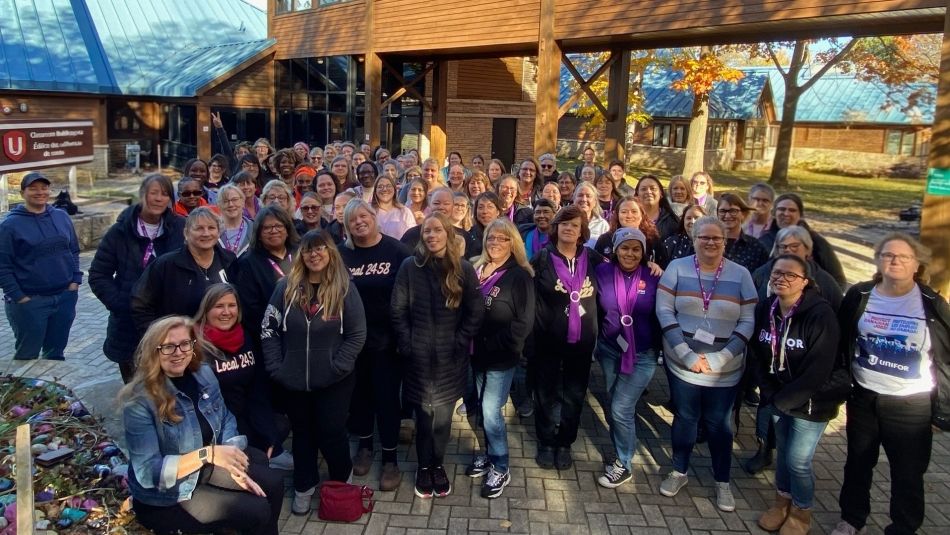 A large group of women posing outside the classrooms at the Unifor Education Centre on a sunny fall day.
