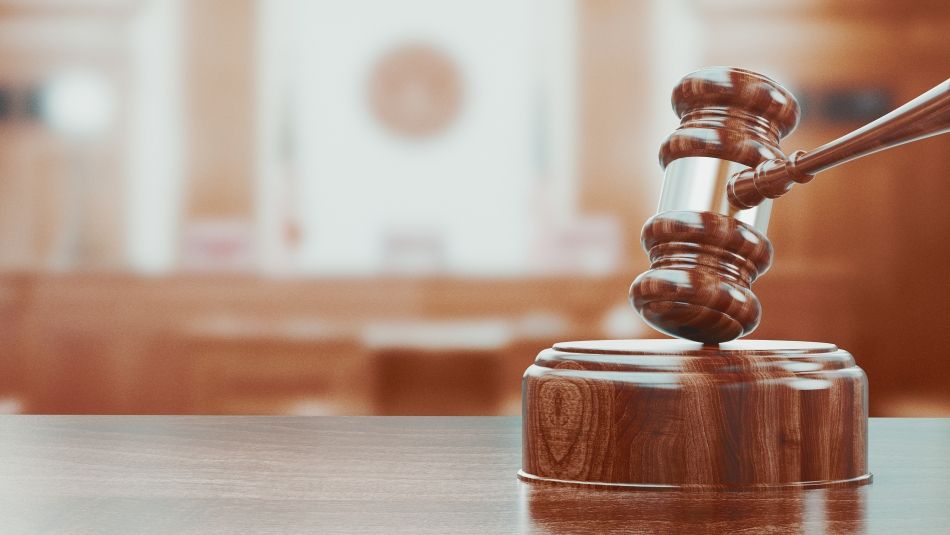 A close-up shop of a wooden gavel on a desk.