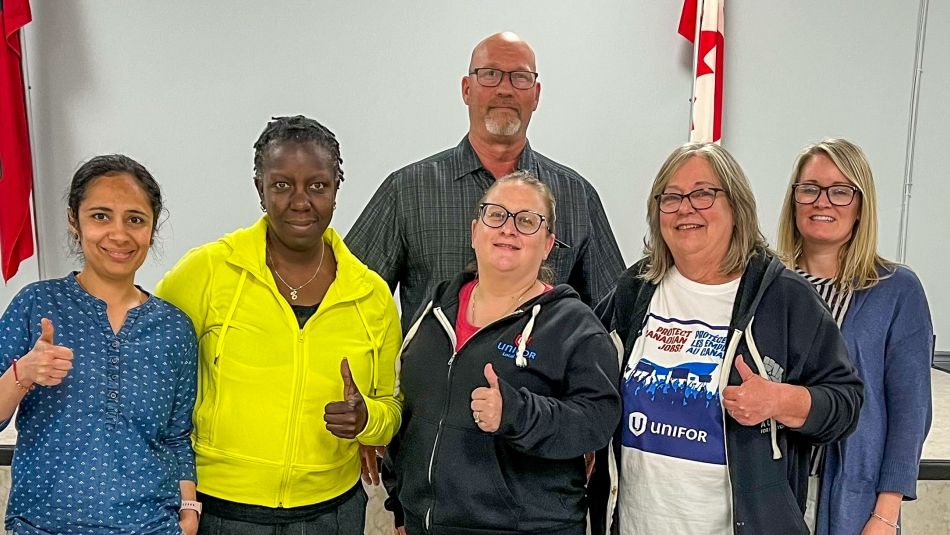 Woodingford Lodge bargaining committee pose with thumbs up