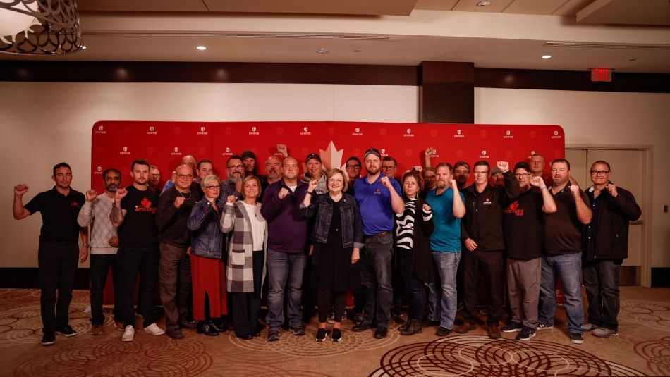 A large group of people standing with their fists up 