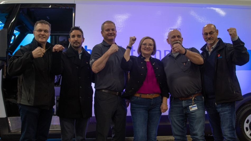 Unifor National President Lana Payne standing with local and national union leaders in front of a GM Brightdrop vehicle