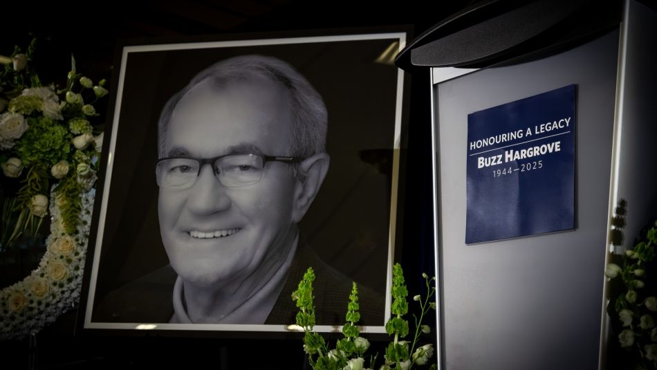 image of Buzz Hargrove with flowers and a podium