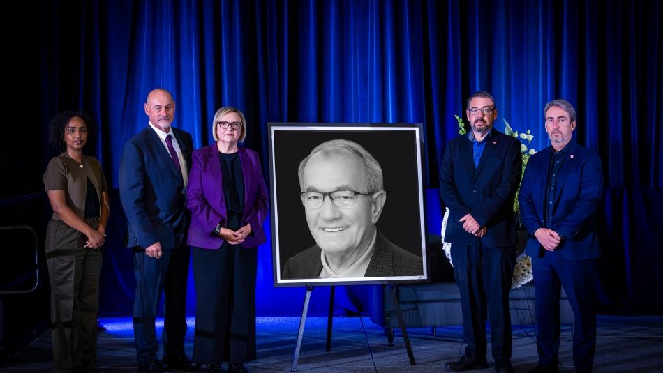 group of people with framed photo of Buzz Hargrove 