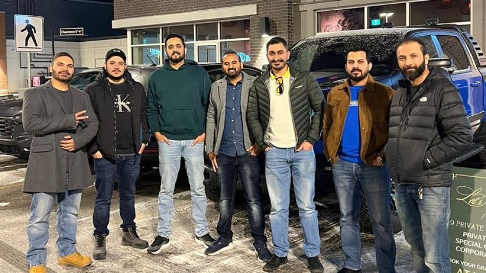 Walmart Fleet Calgary Bargaining Committee Seven men standing outside in a parking lot.
