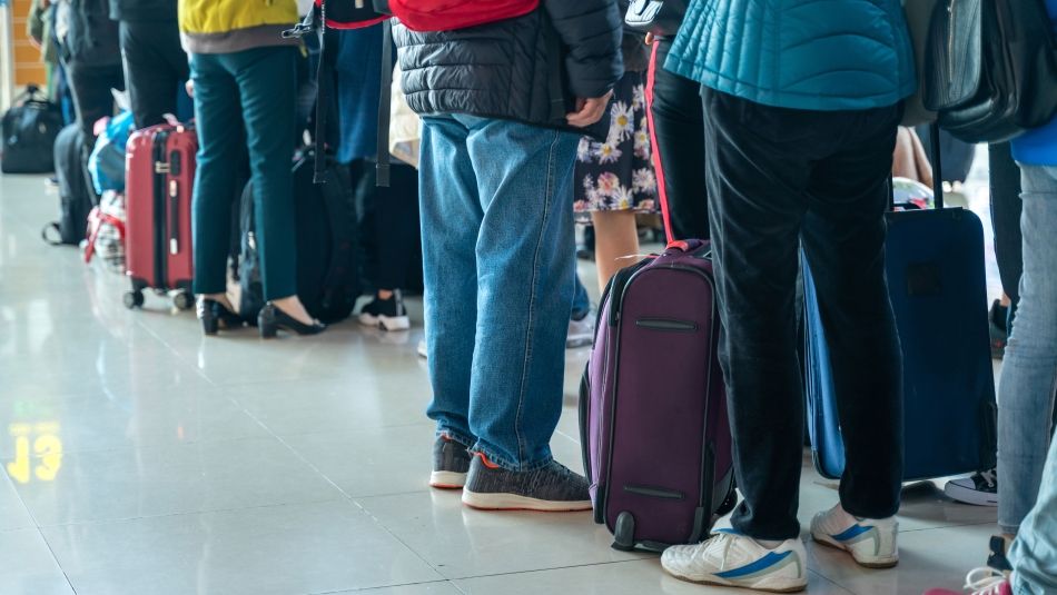 People lining up with baggage