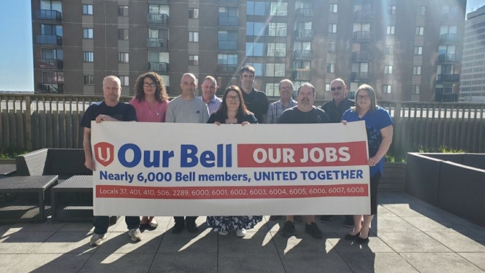 Bell Atlantic Bargaining Committee holding a banner "Our Bell, our jobs"