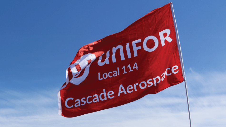 Red Unifor Cascade Aerospace flag in a blue sky with white clouds