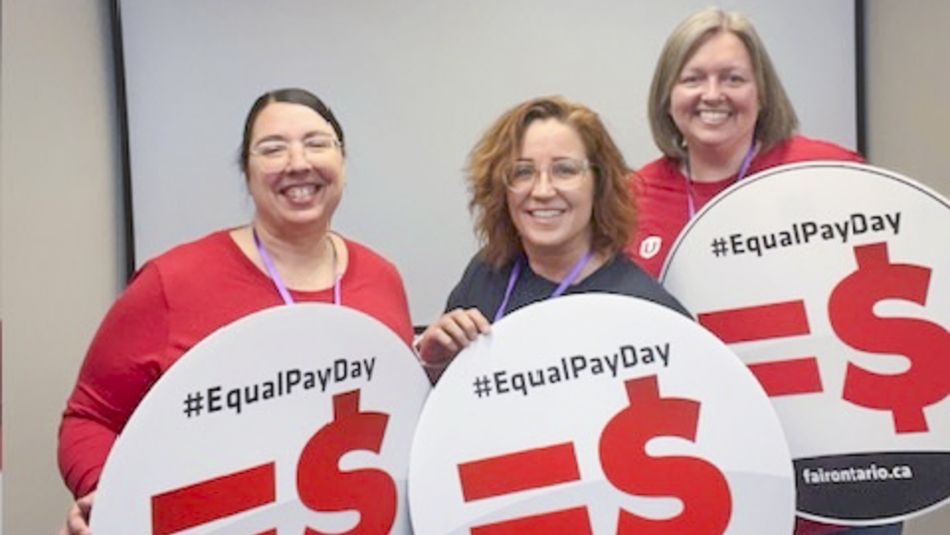 Three people holding up signs that read: =pay day