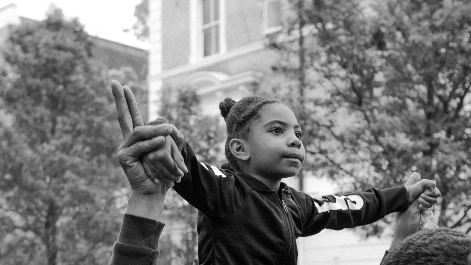 Man carrying girl on his shoulders.