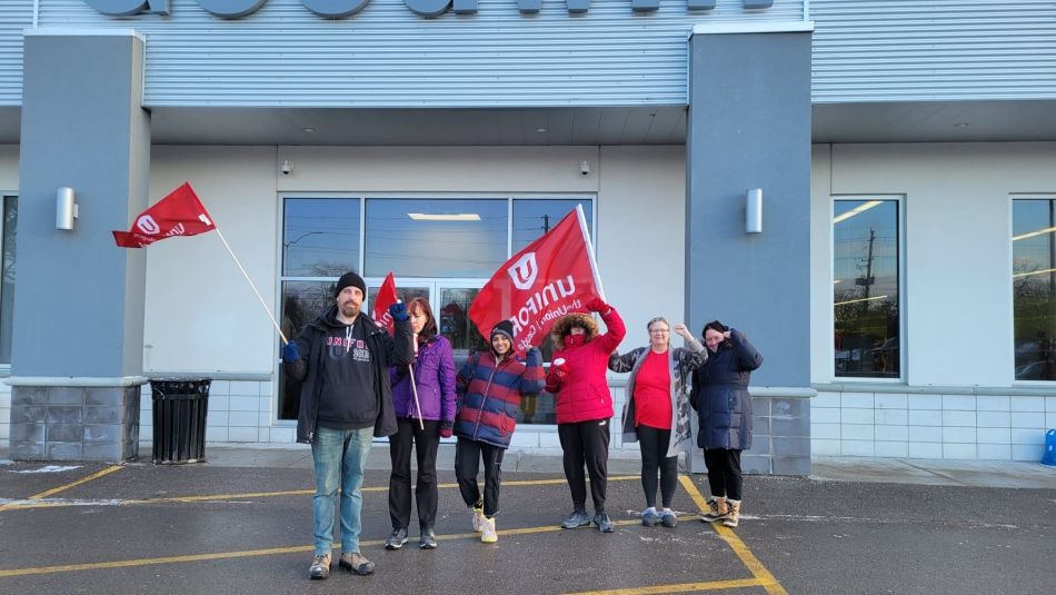 A group of six people in front of Goodwill Industries