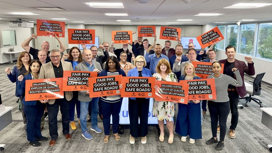 A group of people with orange signs.