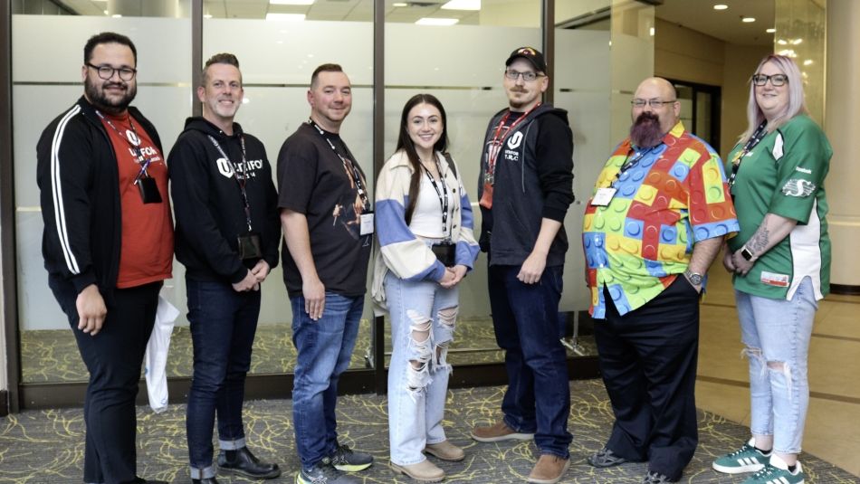 Seven people pose for a photo