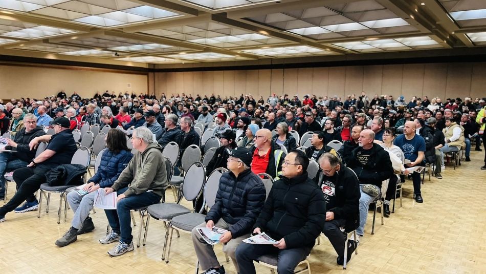 Hundreds of Unifor Local 444 members seated in a large room at a ratification meeting