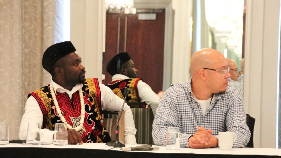 Two men sitting at a panel table.