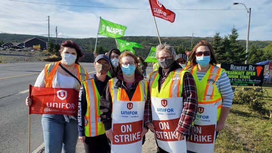 women on the picket line holding signs that read: On strike 