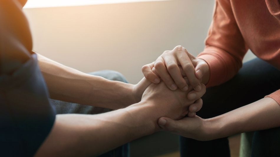 Two people holding hands