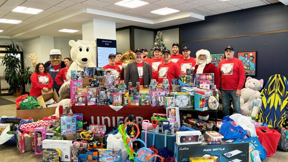 a large toy pile with Santa and helpers