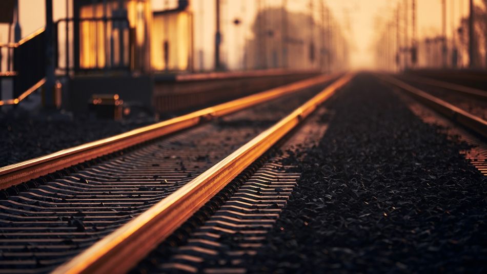 Train tracks in a train yard at sunrise