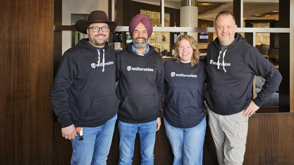 Four people wearing Unifor votes shirts