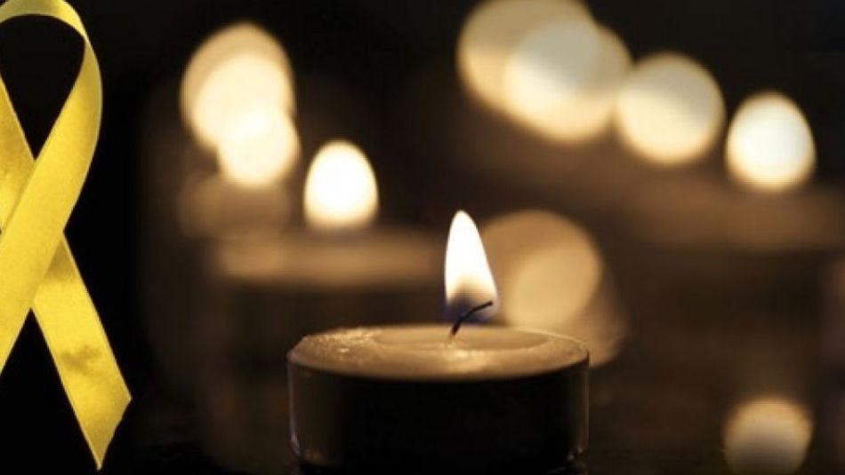 Day of mournng yellow ribbon and lit candles