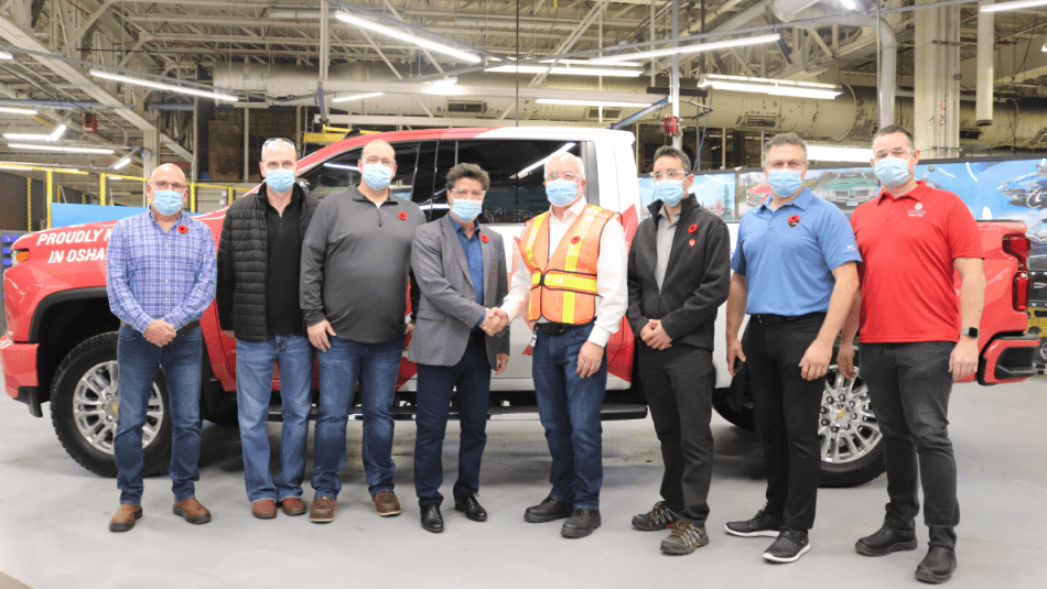 Unifor National President and Unifor Local 222 leadership pose in front of the first truck to roll off the reopened General Motors Oshawa assembly line. 