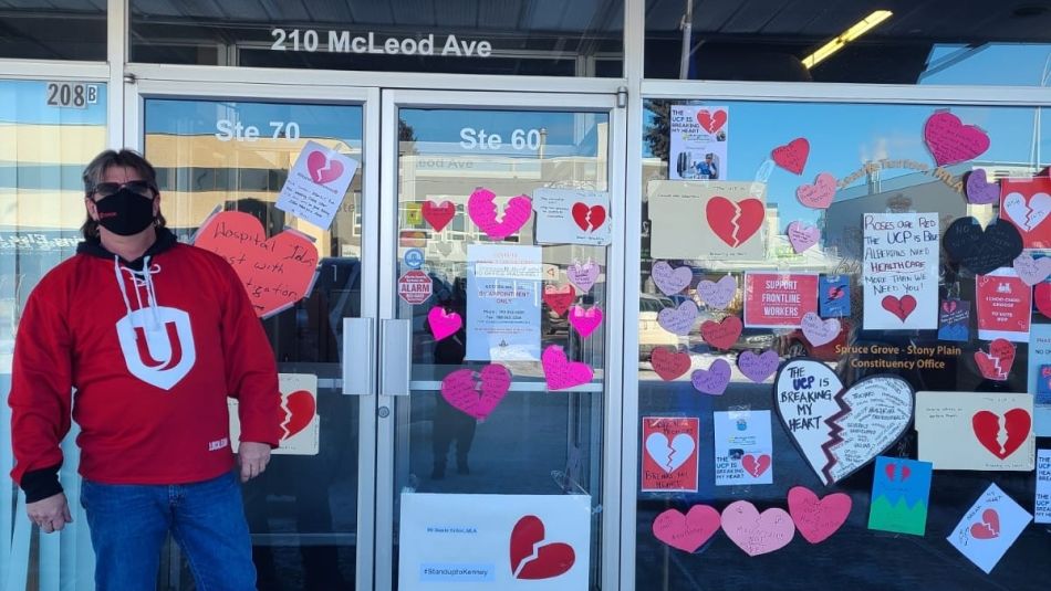 Unifor members take broken heart valentine messages to Alberta MLAs offices. 