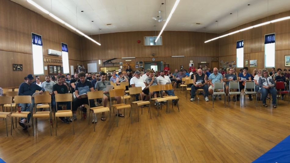 Dozens of members of Local 1944 seated in a meeting hall.