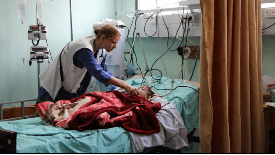 A doctor in a hospital in Gaza tends to a young child.