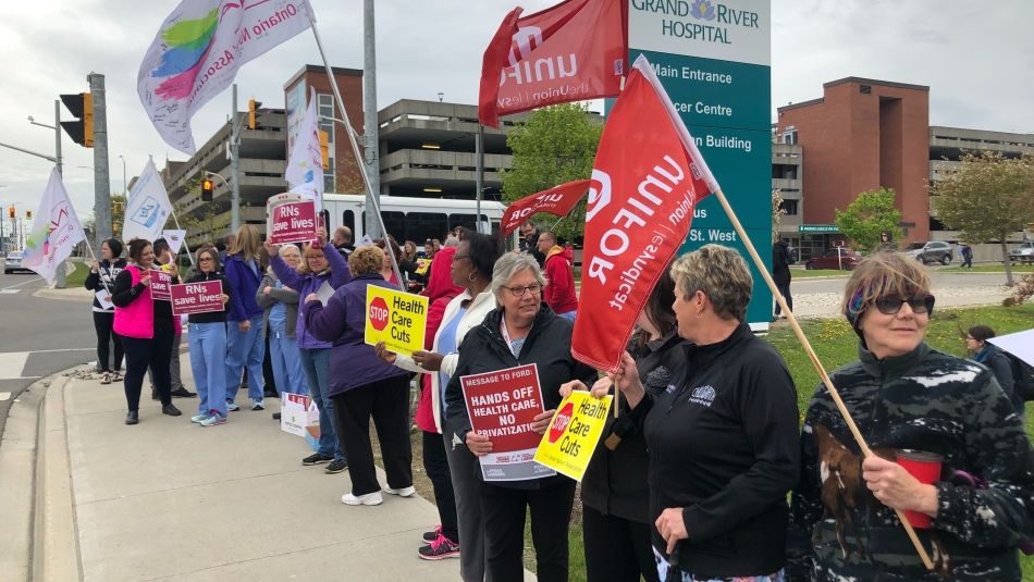 A group of Unifor health care workers rally against cuts at Grand River Hospital in Kitchner-Waterloo